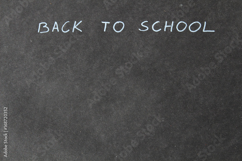 Hand writing back to school. Blackboard