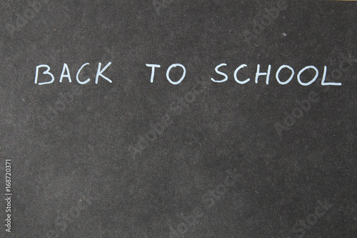 Hand writing back to school. Blackboard