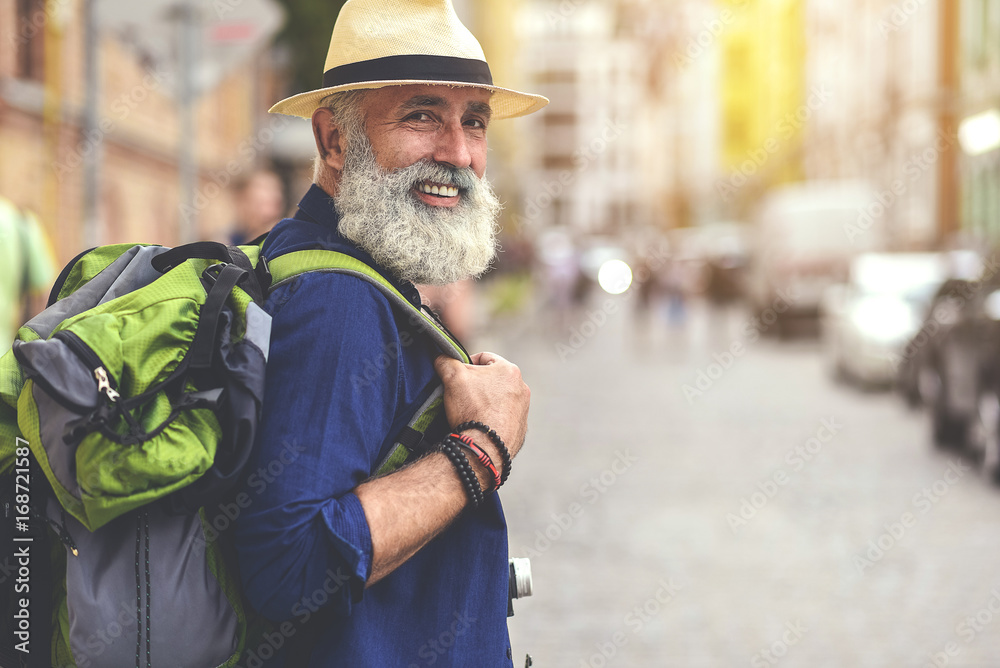 Excited senior male traveler enjoying walk in town Excited senior male traveler enjoying walk in town