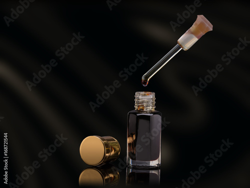 Incense of Traditional Arabian Fragrance oil in a glass jar on black background photo