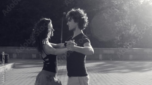 Young couple dancing on the square photo