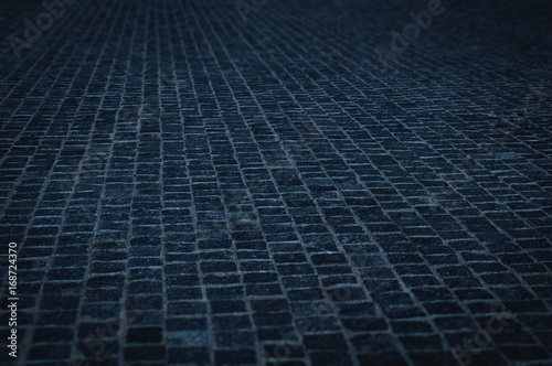cobble stone pavement street in an urban night - cobblestone pattern with blue color tone © Lightstone