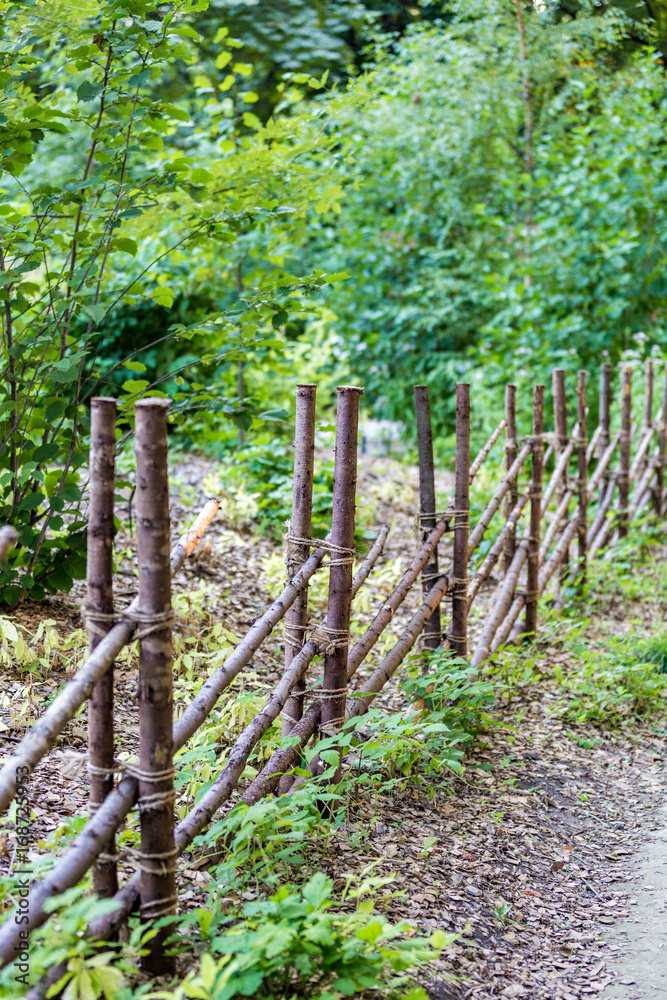 Fence from the trunks of trees in the green city park
Fence from the trunks of trees in the green city park