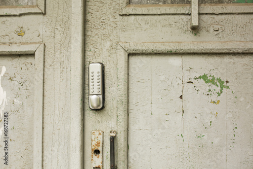 Outdoor intercom on an old cracked door © vpavlyuk