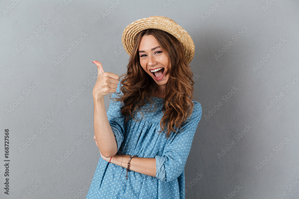 Smiling young pretty woman showing thumbs up. Looking camera. Smiling young pretty woman showing thumbs up. Looking camera.
