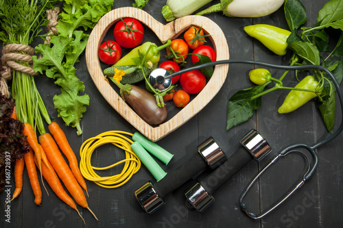 Fresh vegetables in the heart. Diet, healthy lifestyle on a black background