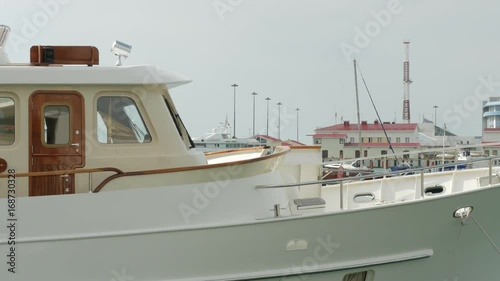 Luxury motor boat swings on waves in the Port of Sochi, Rissia photo