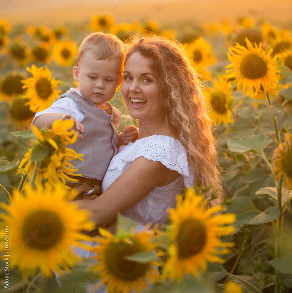 Mother with baby son in sunflower field Mother with baby son in sunflower field