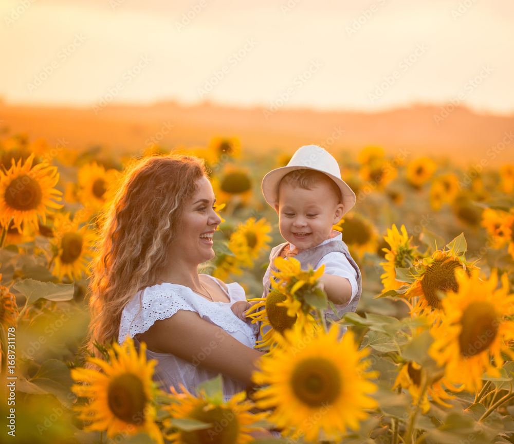 Mother with baby son in sunflower field Mother with baby son in sunflower field