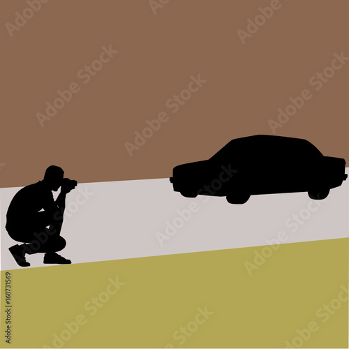 Black man photographer's silhouette taking a photo of a car