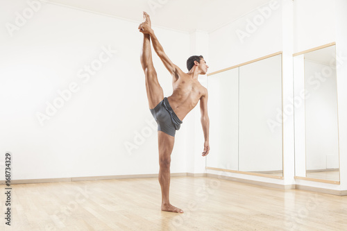 ballet dancer stretching and warming up using foam roller