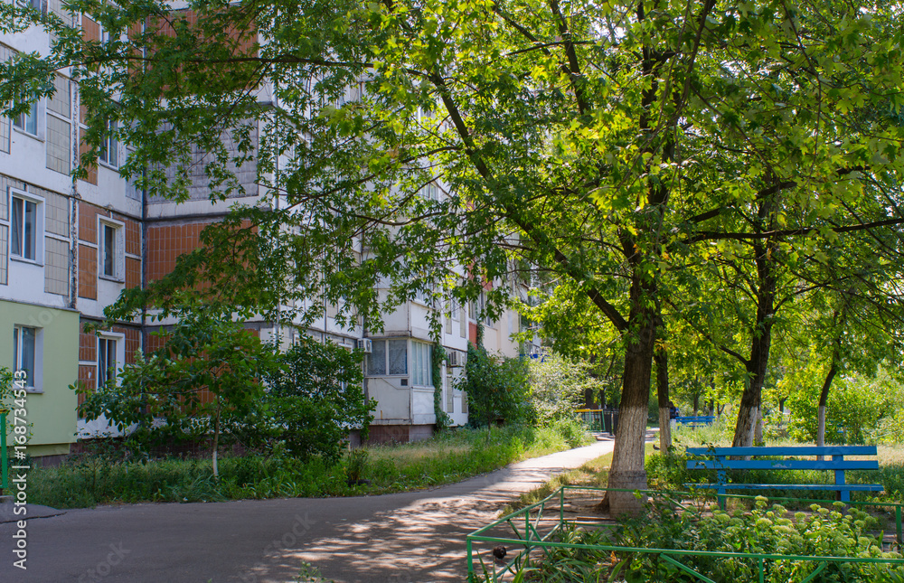 contrasts meet in such street scenes in summer in the capital of Ukraine, Kiev, as the green and idyllic city is full of pragmatic soviet era residential buildings towering over the urban nature