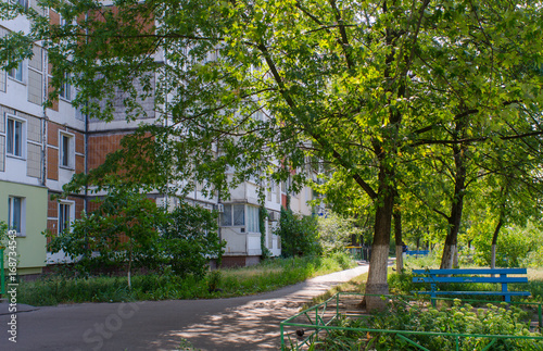 contrasts meet in such street scenes in summer in the capital of Ukraine, Kiev, as the green and idyllic city is full of pragmatic soviet era residential buildings towering over the urban nature