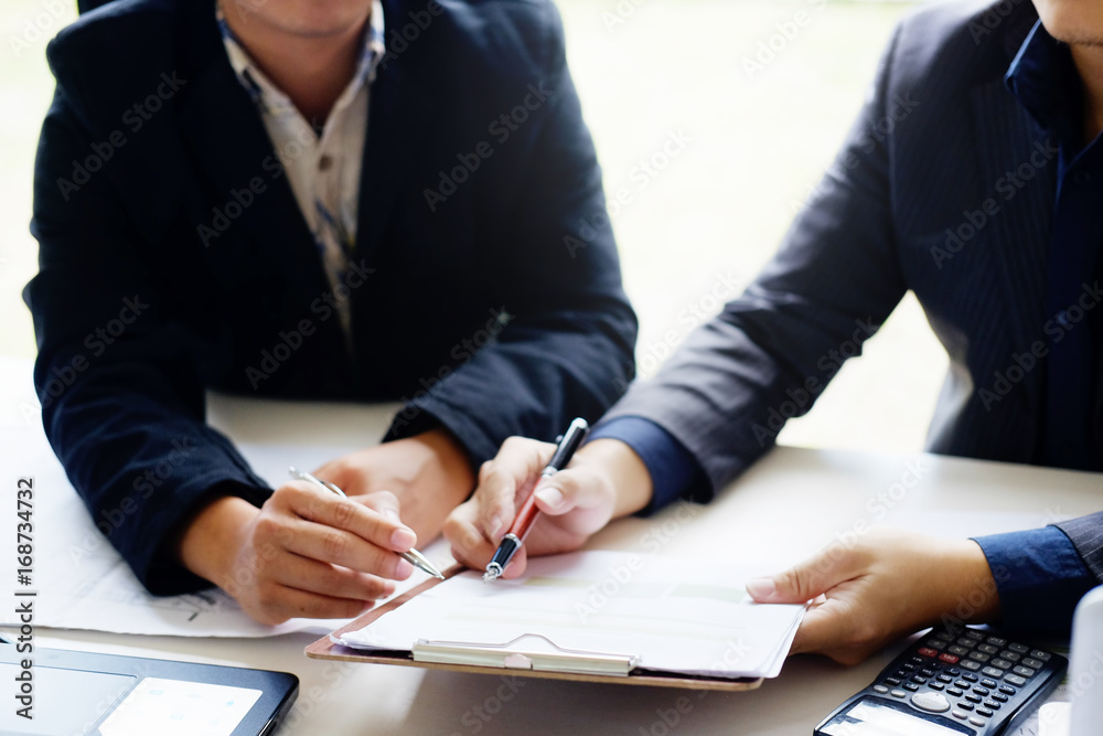 business man talking to consult report paper of financial in office. business man talking to consult report paper of financial in office.