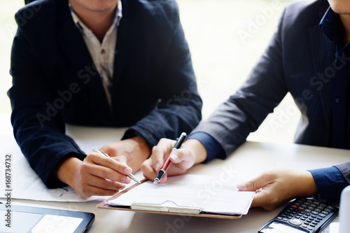 Obraz na plátně business man talking to consult report paper of financial in office