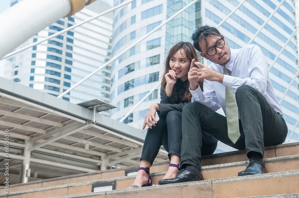 Asian Business couple sitting and talking about their work. Asian Business couple sitting and talking about their work.