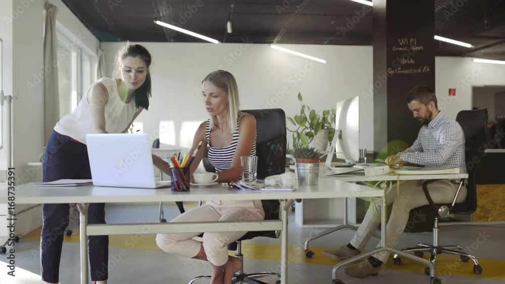 Three business people in the office working. Three business people in the office working.
