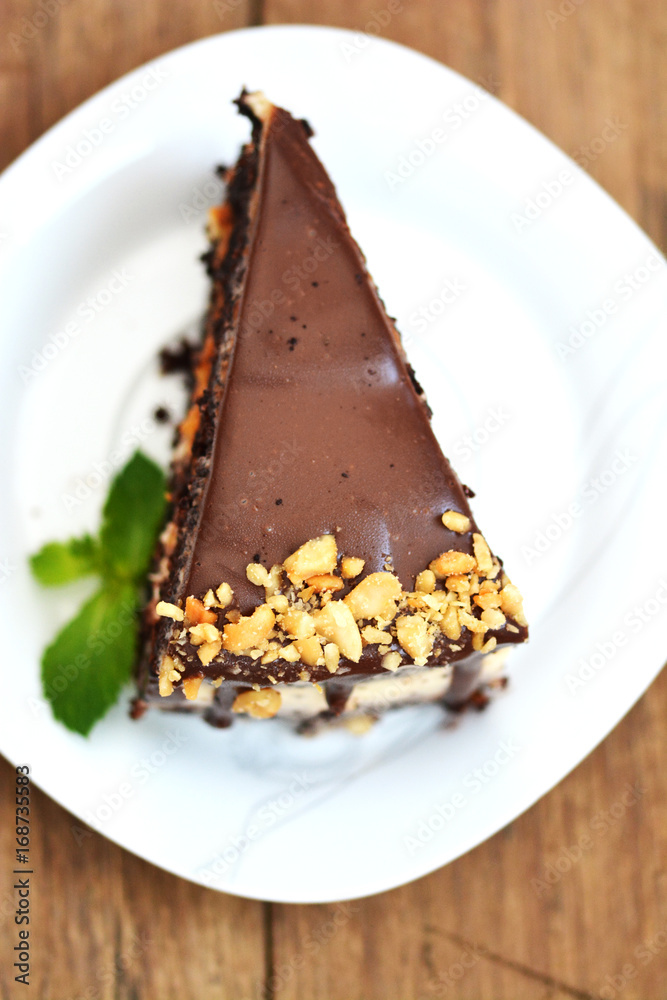 Top view of tasty chocolate cake with nuts on white plate Top view of tasty chocolate cake with nuts on white plate