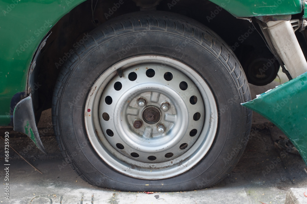 Car Flat tire and Bumper crash damage from accident waiting to claim with insurance company.