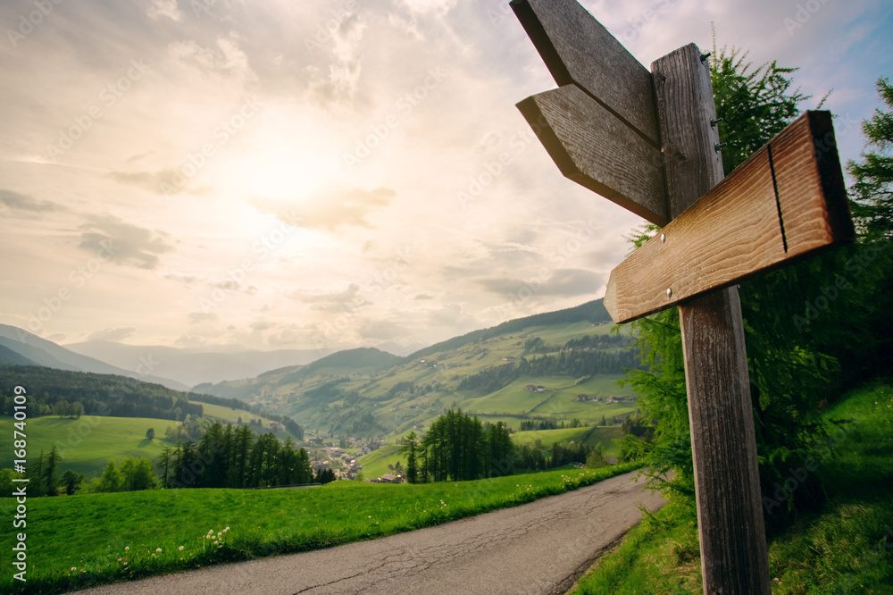 Fototapeta Empty wooden arrow sign near mountains landscape