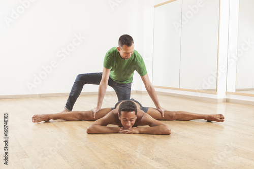 pilates instructor teaching a ballet dancer