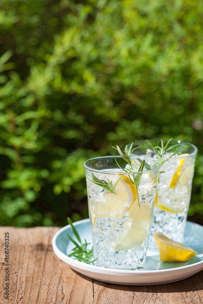 refreshing lemonade drink with rosemary in glasses