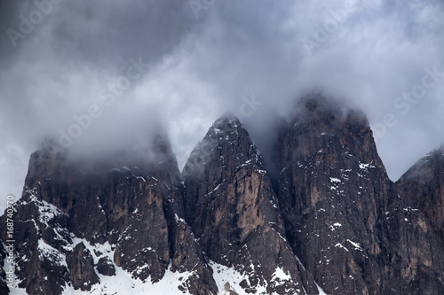 Cloudy snowy mountains peaks landscape. Dolomites Alps