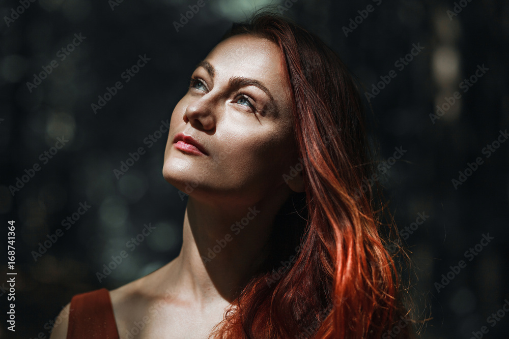 Portrait of a beautiful red-haired girl on a background of nature Portrait of a beautiful red-haired girl on a background of nature