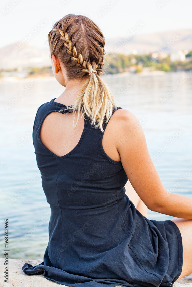Young woman relaxing by the seaside in Croatia Young woman relaxing by the seaside in Croatia
