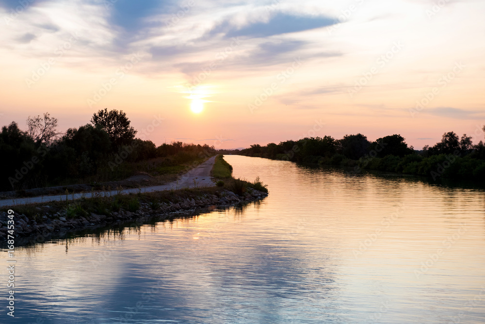 Sunset over a canal in the Camargue, France