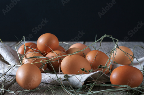 Fresh chicken brown eggs on rustic wood, organic farming concept photo