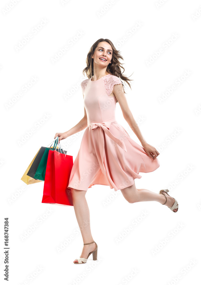 Happy running beautiful woman with many shopping bags