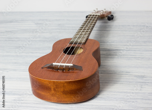 Close up of ukulele on old wooden background photo