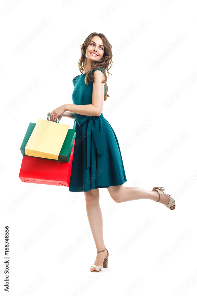 Happy beautiful woman holding many colorful shopping bags isolated on white background