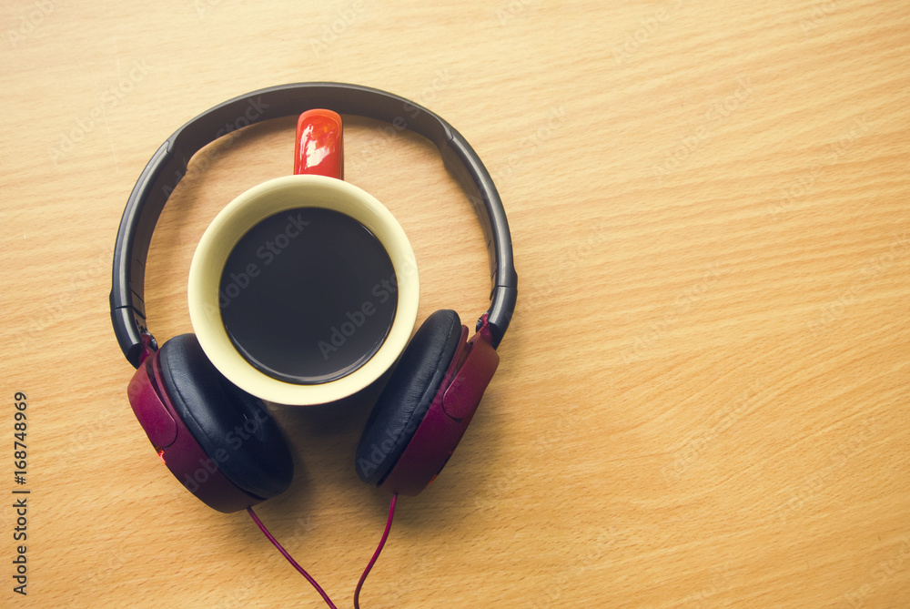 coffee hot cup with music headphone in holiday concept coffee hot cup with music headphone in holiday concept