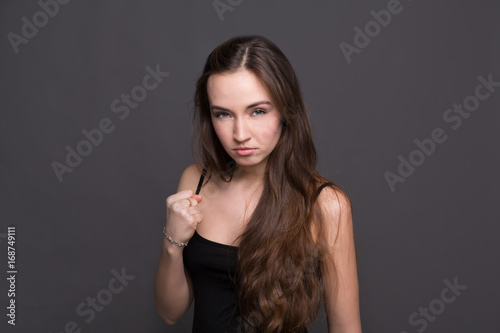 Young attractive woman showing punch gesture.