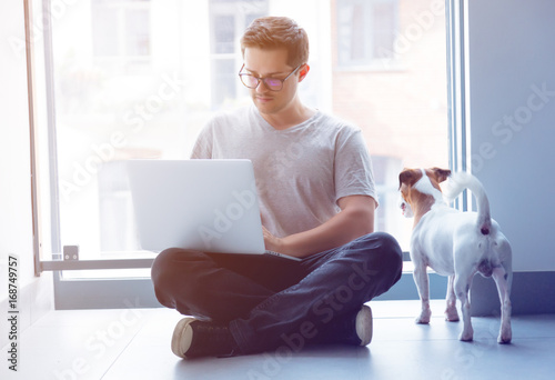 Handsome young freelancer man using laptop computer
