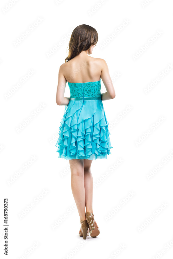 Fototapeta premium Back view of young beautiful woman in turquoise cocktail dress