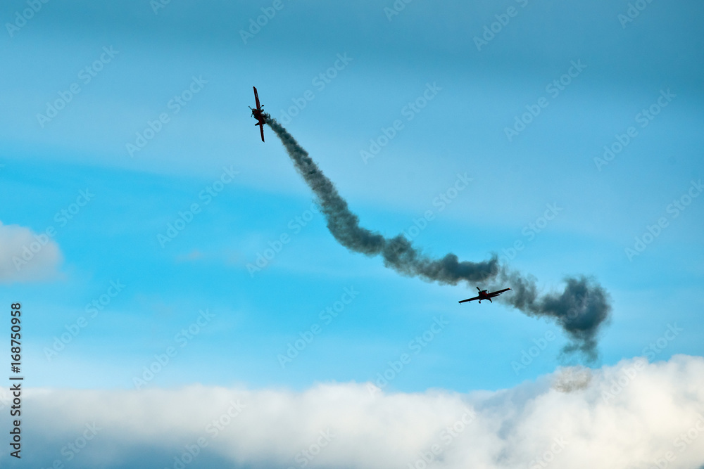 Two planes on the blue cloudy sky during the airshow. Two planes on the blue cloudy sky during the airshow.