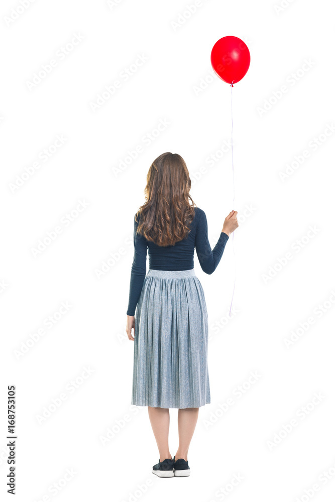 Back view of young beautiful woman holding one red balloon Back view of young beautiful woman holding one red balloon