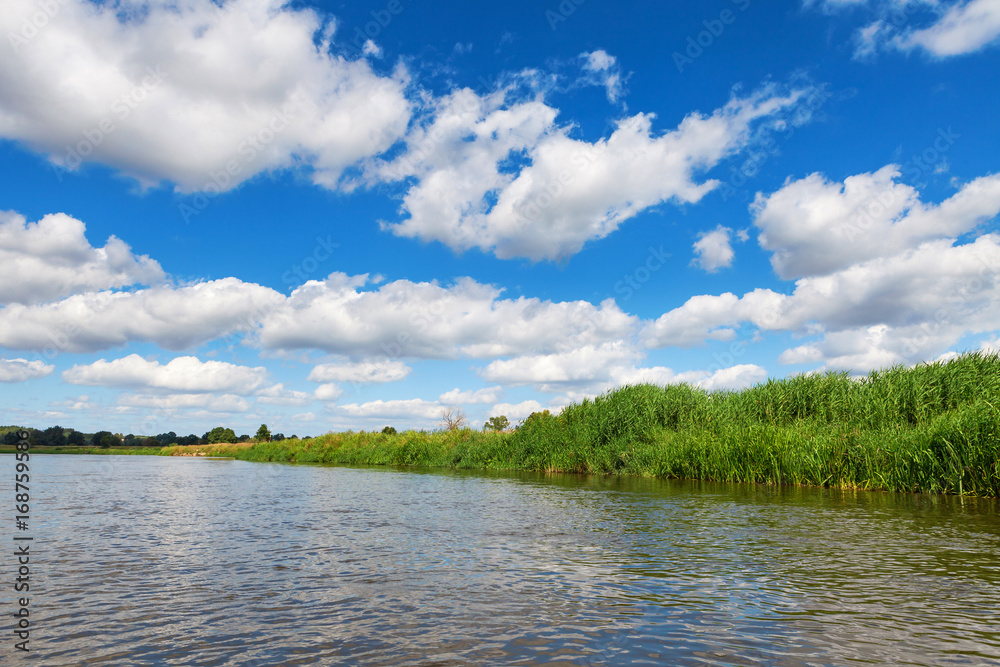 Blue cloudy summer sky over Bug river, Poland, Europe Blue cloudy summer sky over Bug river, Poland, Europe