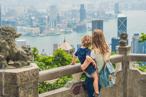 Mom and son travelers at the peak of Victoria against the backdrop of Hong Kong. Traveling with children concept photo