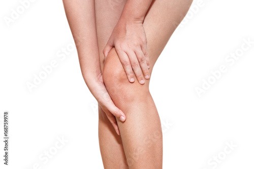 Woman touching her injured knee isolated on white background.