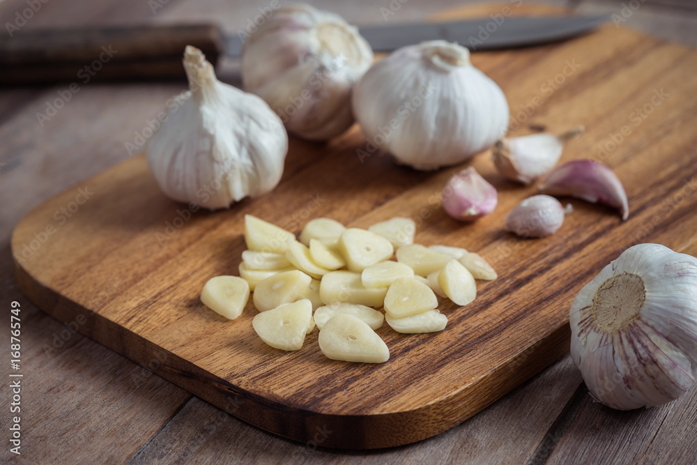Garlic on wooden cutting board Garlic on wooden cutting board