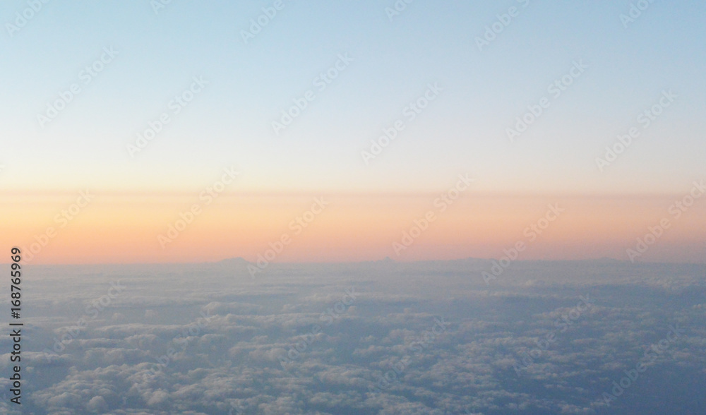 Flying above the sunrise clouds. view from the airplane, soft focus