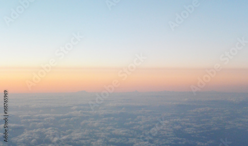 Flying above the sunrise clouds. view from the airplane, soft focus