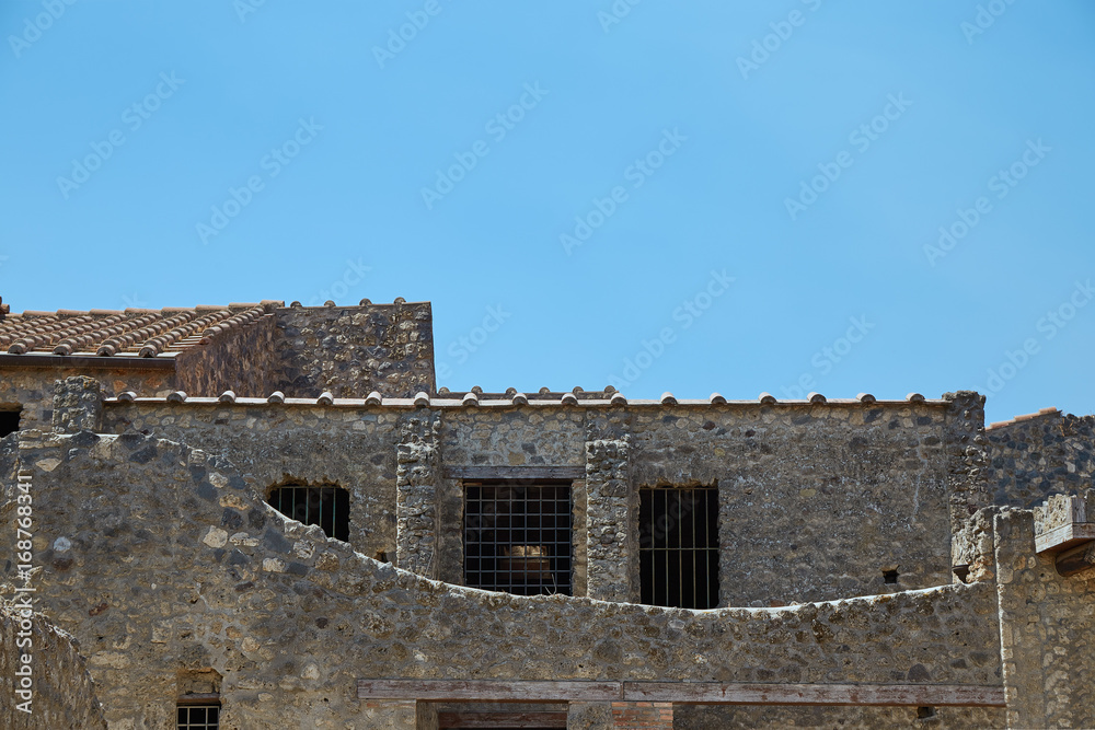 Part of the surviving house with windows and a roof in Pompeii, Italy