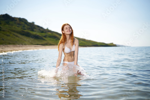 Beautiful young woman is resting on the sea, ocean, beach,let, sun