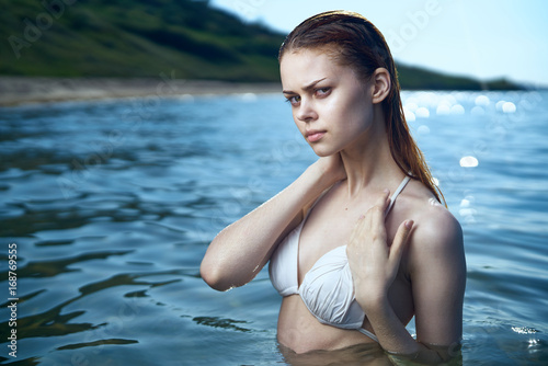 Beautiful young woman is resting on the sea, ocean, beach,let, sun