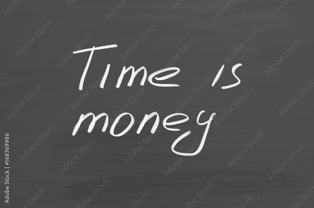 Obraz premium Time is money. Text on chalkboard